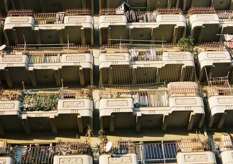 a building with several balconies and bird cages