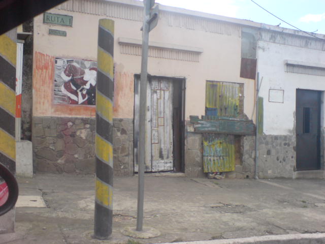 an empty road with several doors, and some signs