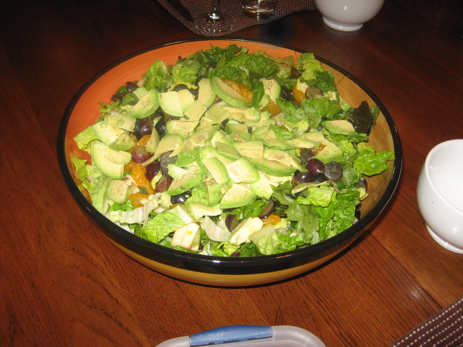 a large salad is in a brown bowl on a table