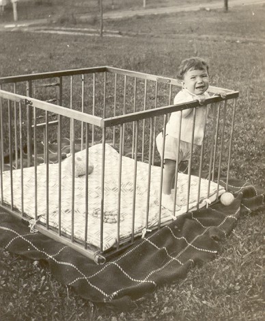 an old po of a baby in a cage
