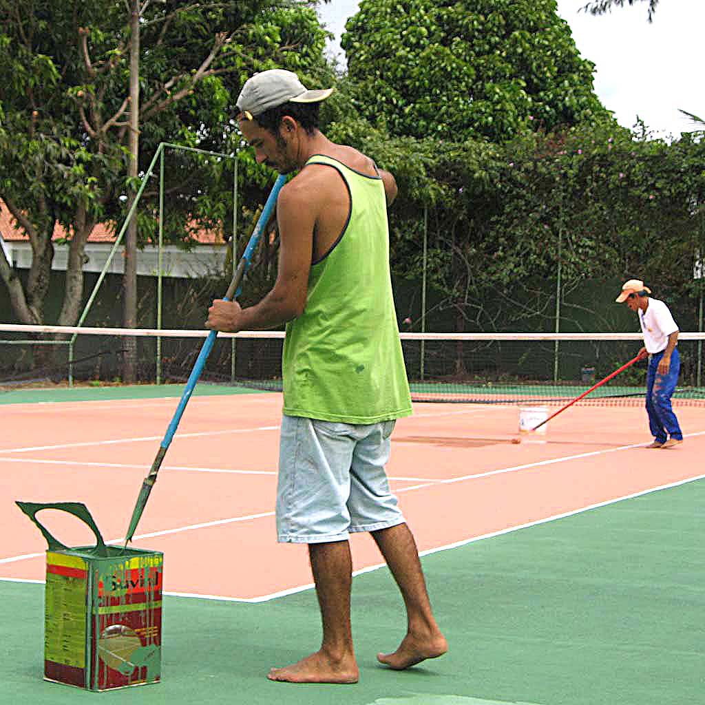 a man holding a tennis racquet on a court
