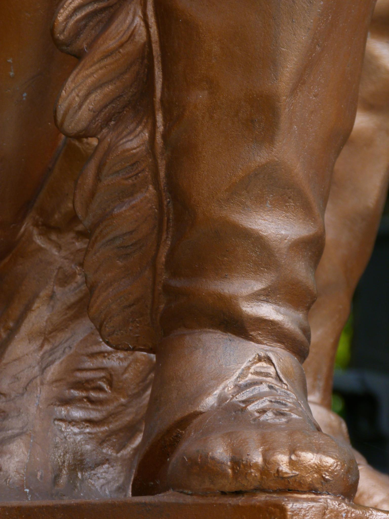 a close up of the feet of a statue