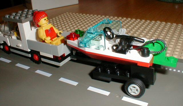 a small lego boat is being transported by a truck