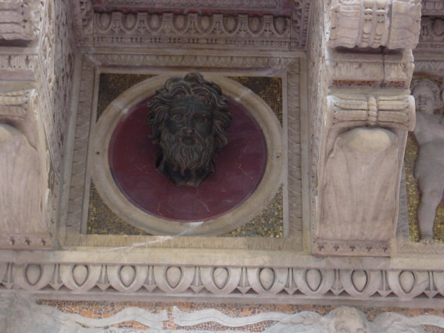 an ornately designed and painted stone and stucco sculpture