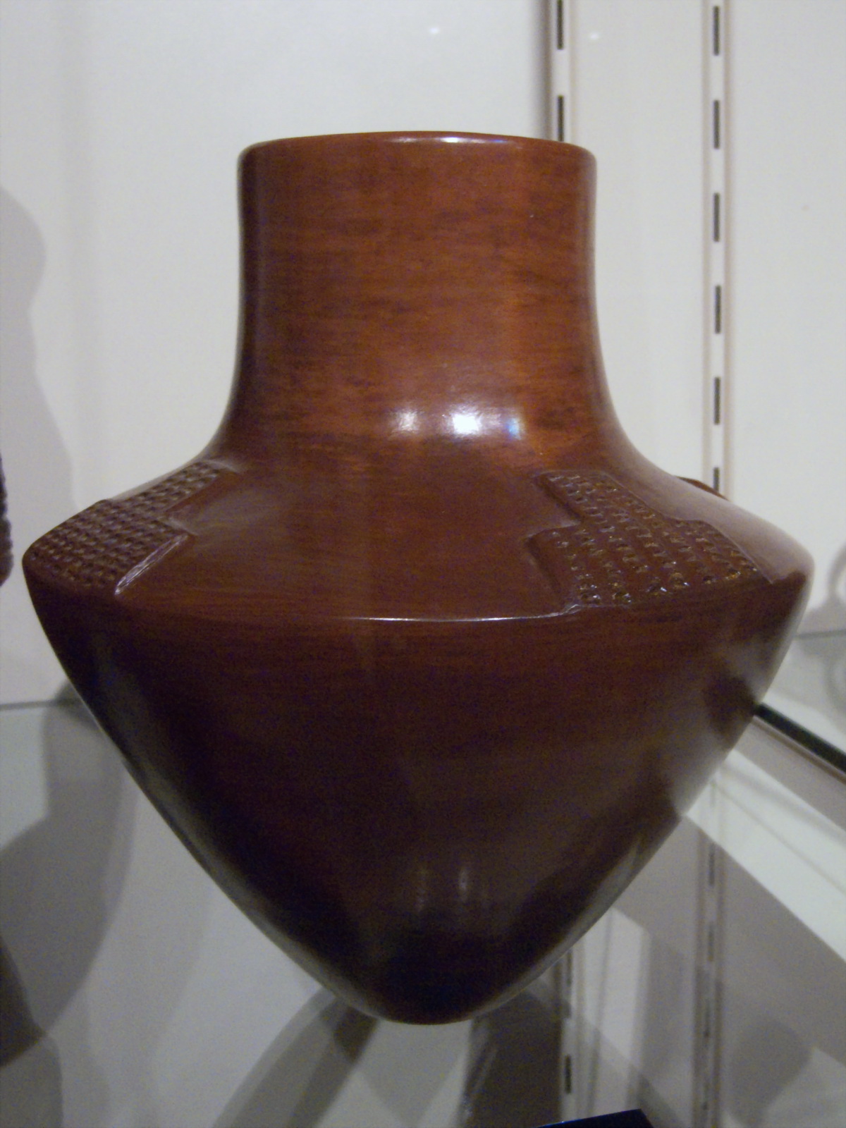 a close up of an art deco vase in a room