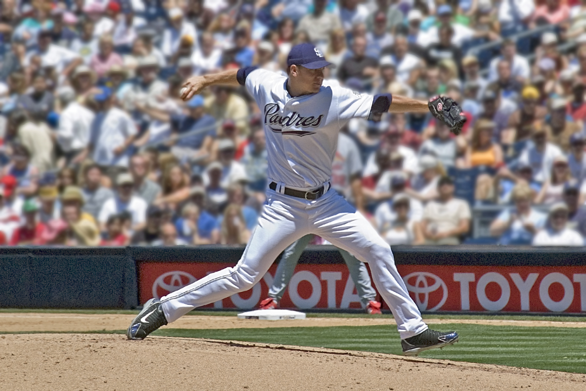 a baseball player in a white uniform is throwing a ball