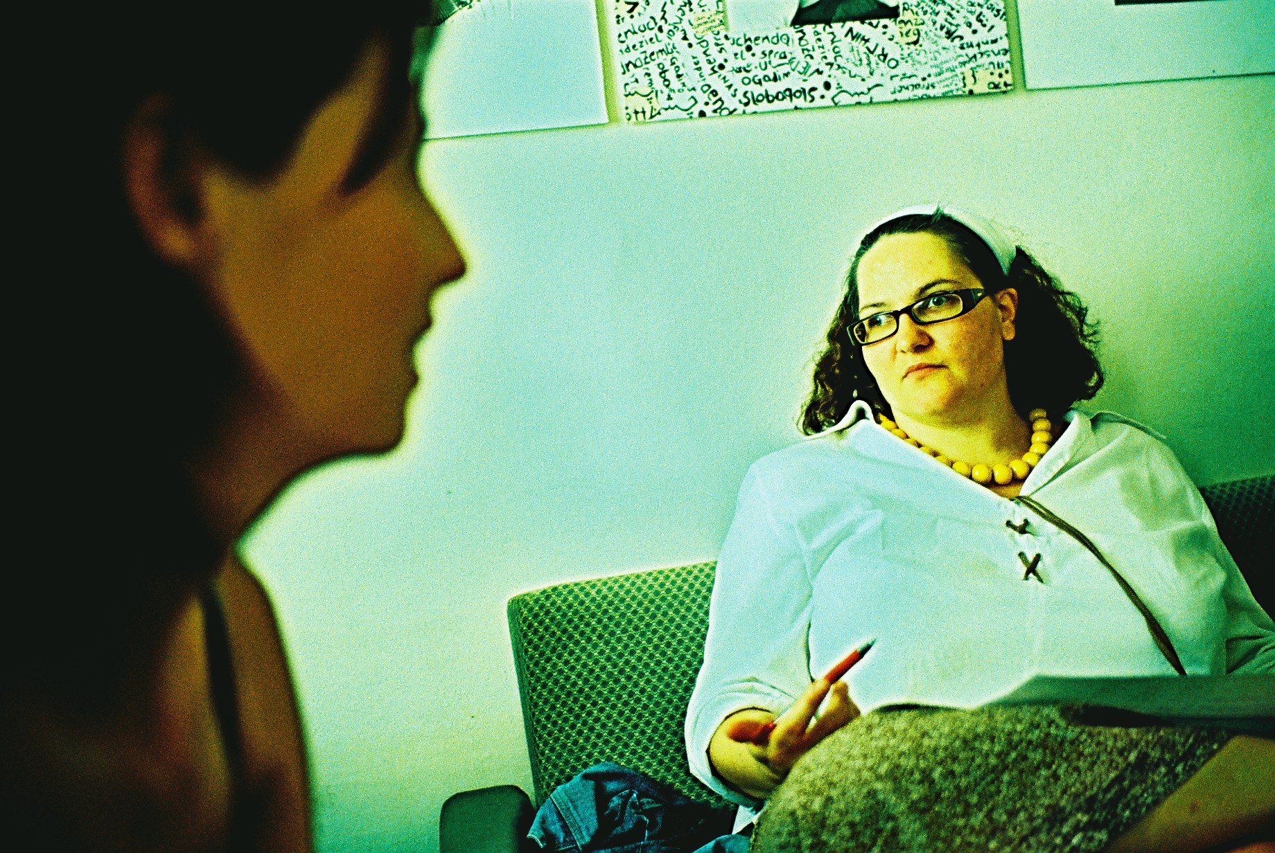 a lady sitting down talking to another woman