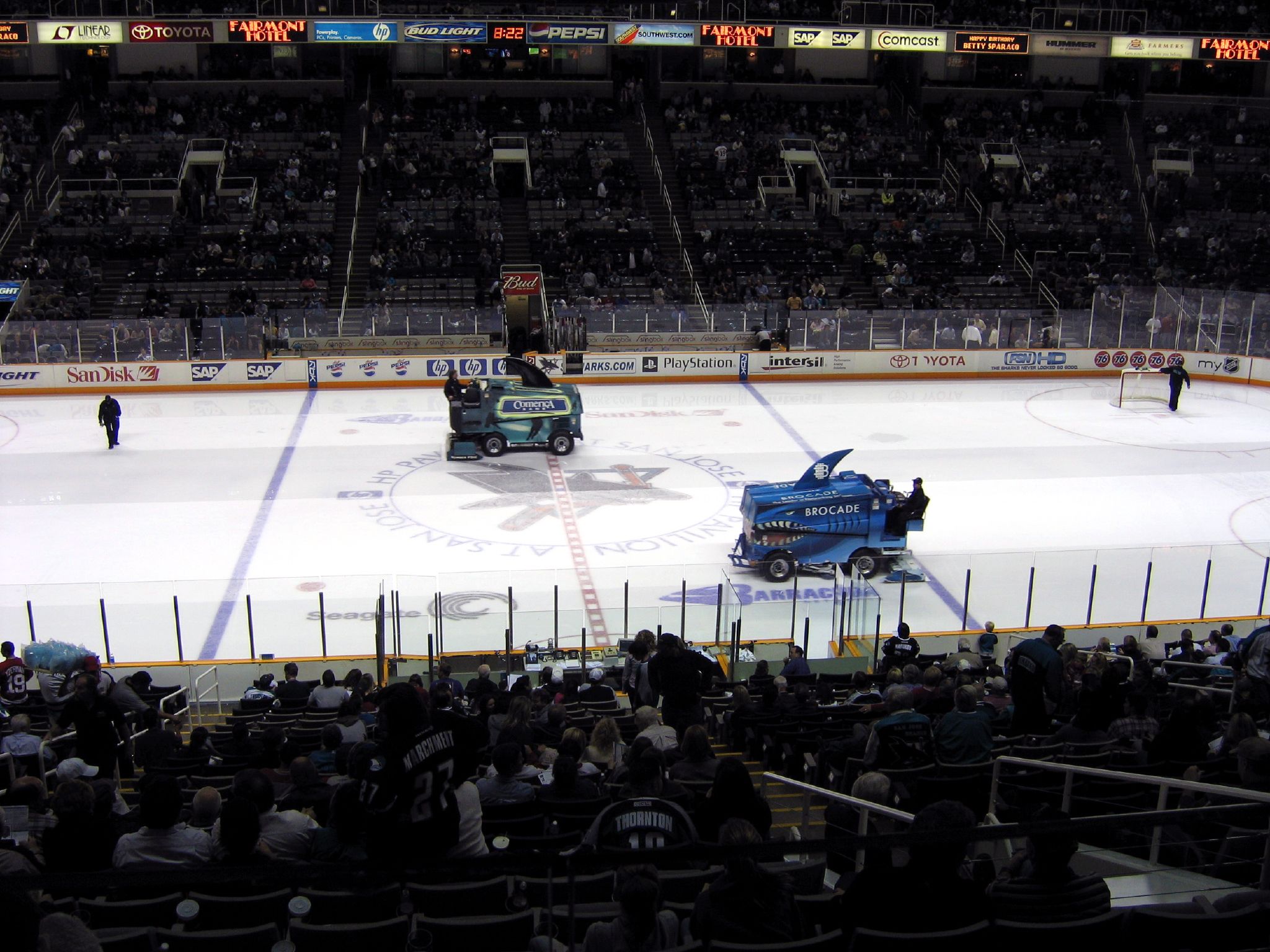 the hockey field has an ice rink with many players