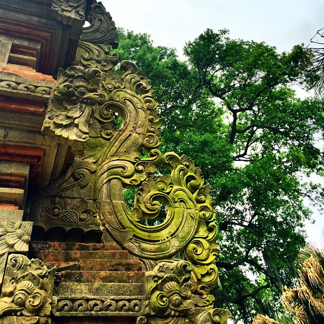 an old wall carving at a temple on a cloudy day