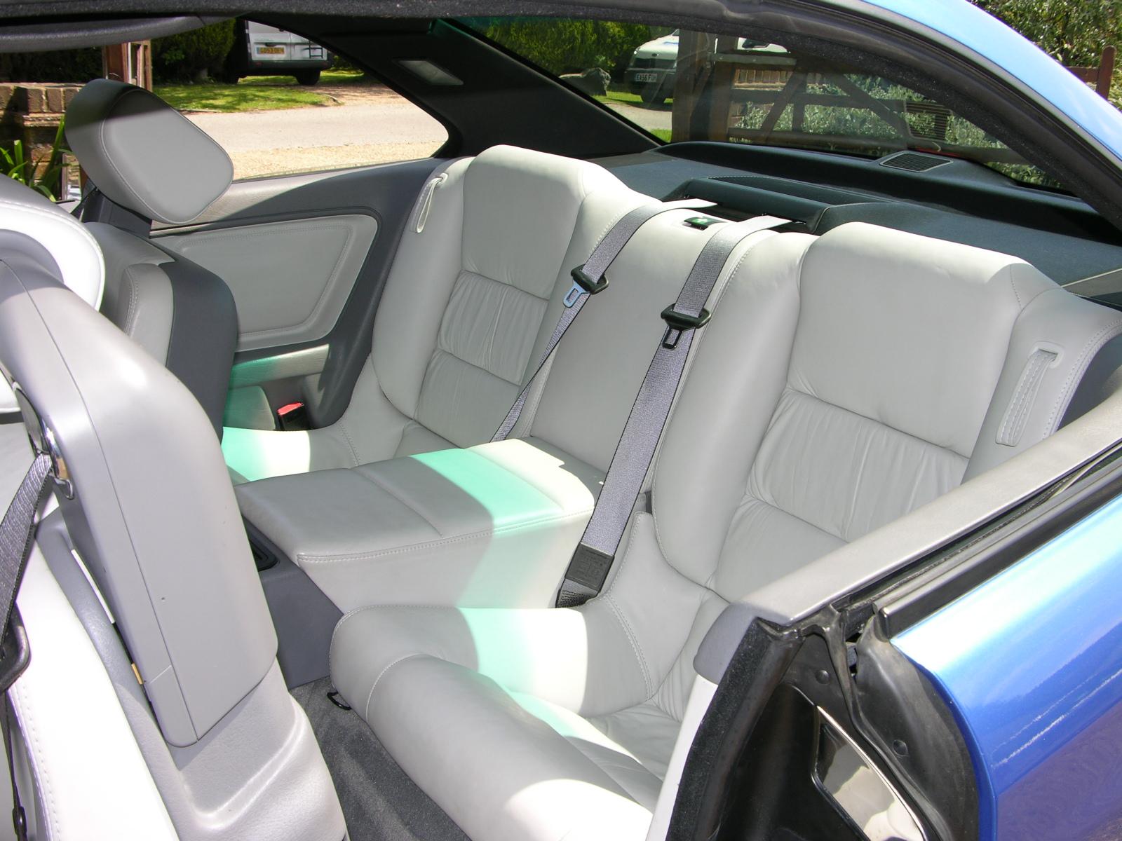 a car with four seats and a light blue dash board