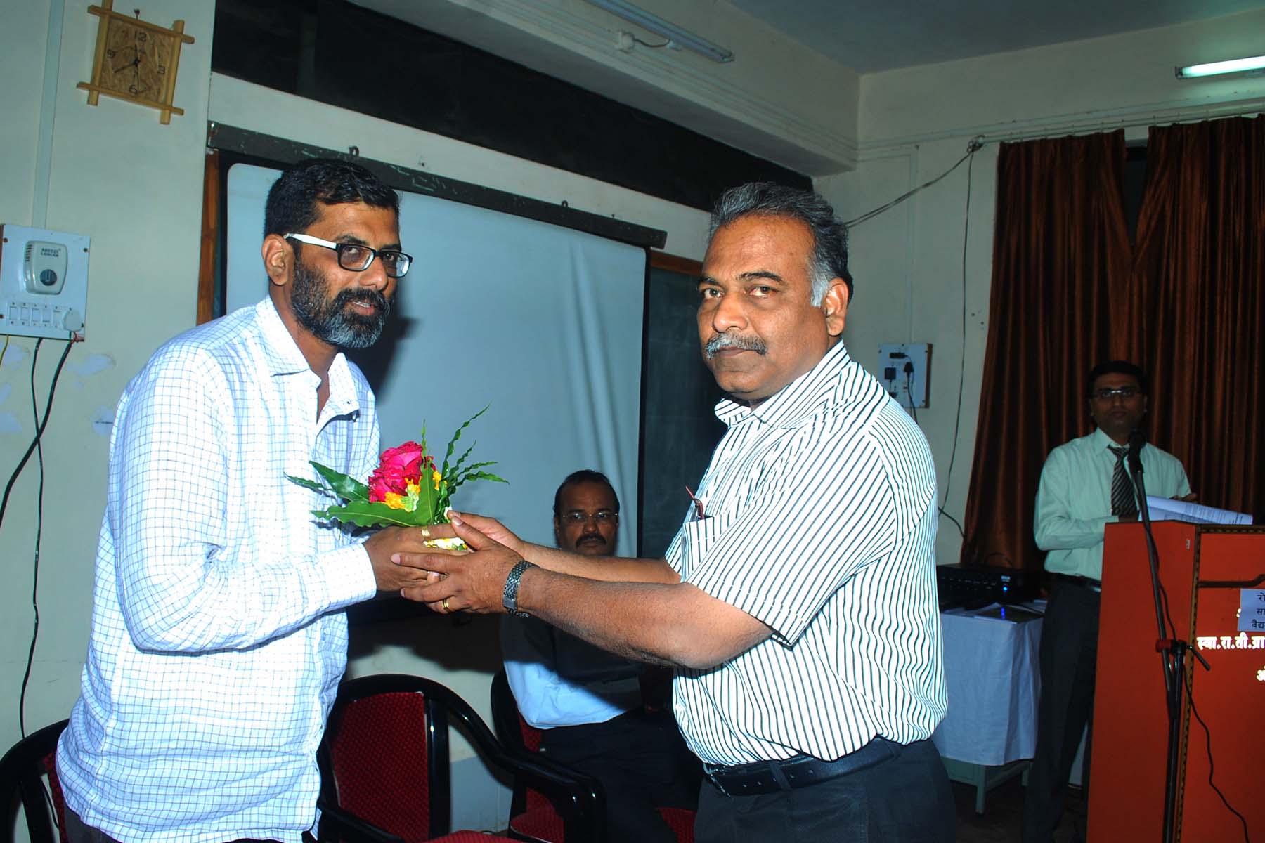 a man receiving a bouquet of flowers from another person