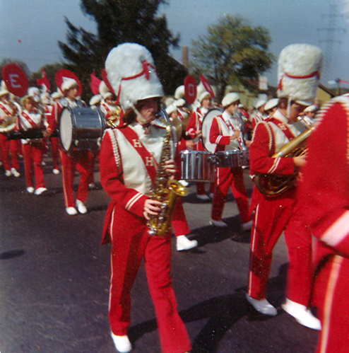 the marching band performs on the street