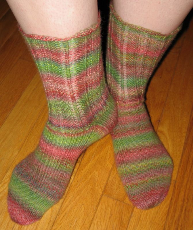a person wearing colorful socks and shoes on the floor