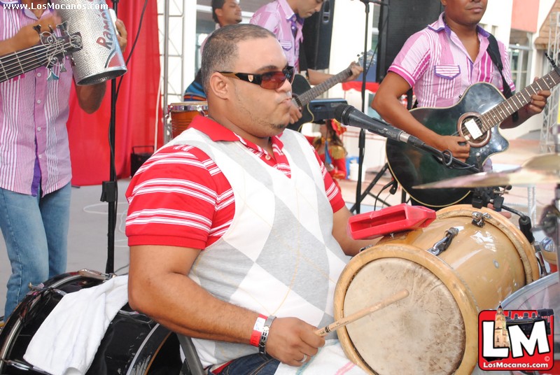 a man in sunglasses is playing drums and other instruments