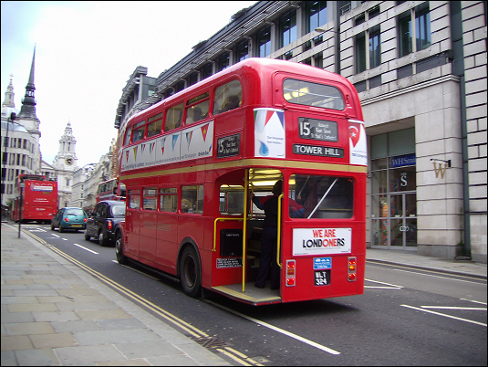 a double decker bus drives past the traffic
