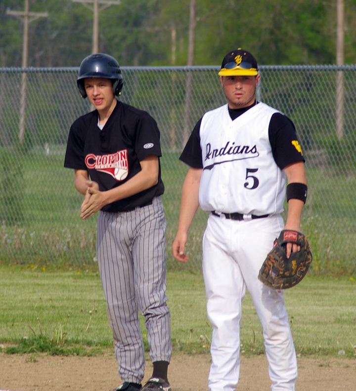 a couple of baseball players standing next to each other