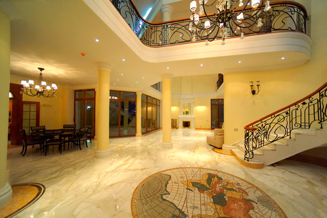 a large foyer with marble floors and stairs