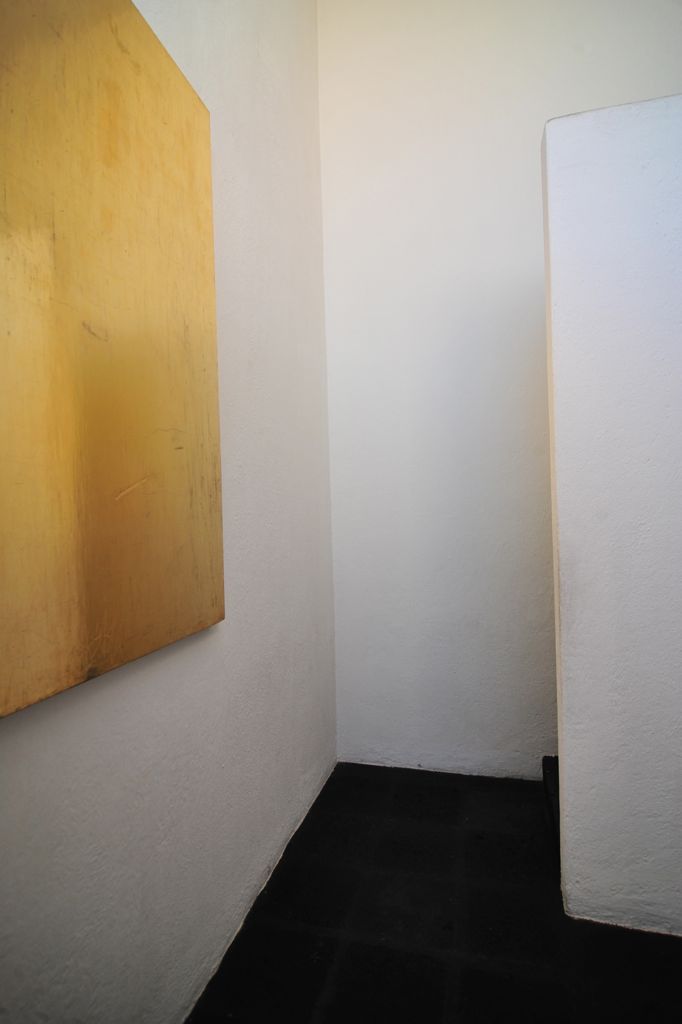 an empty white room with a painting in it