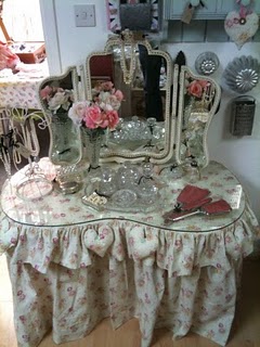 a pink and white dresser with a mirror on top