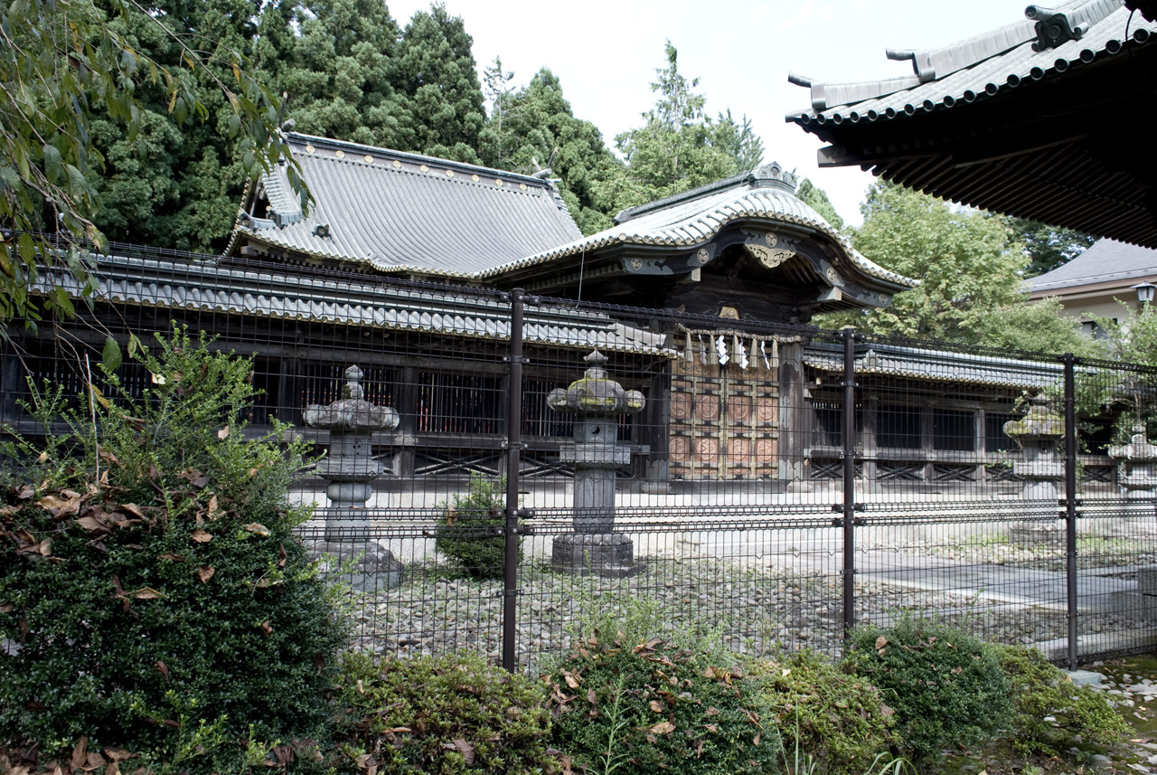 an oriental courtyard with metal fence and columns