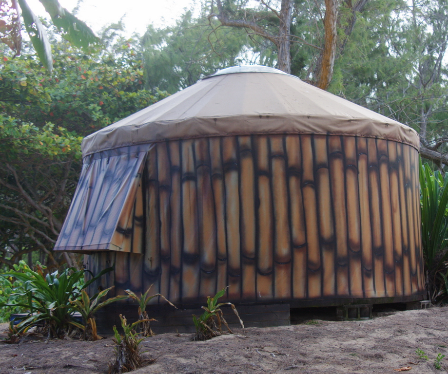 a round building surrounded by plants and trees