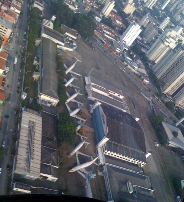 an aerial view of two planes that are parked in front of buildings