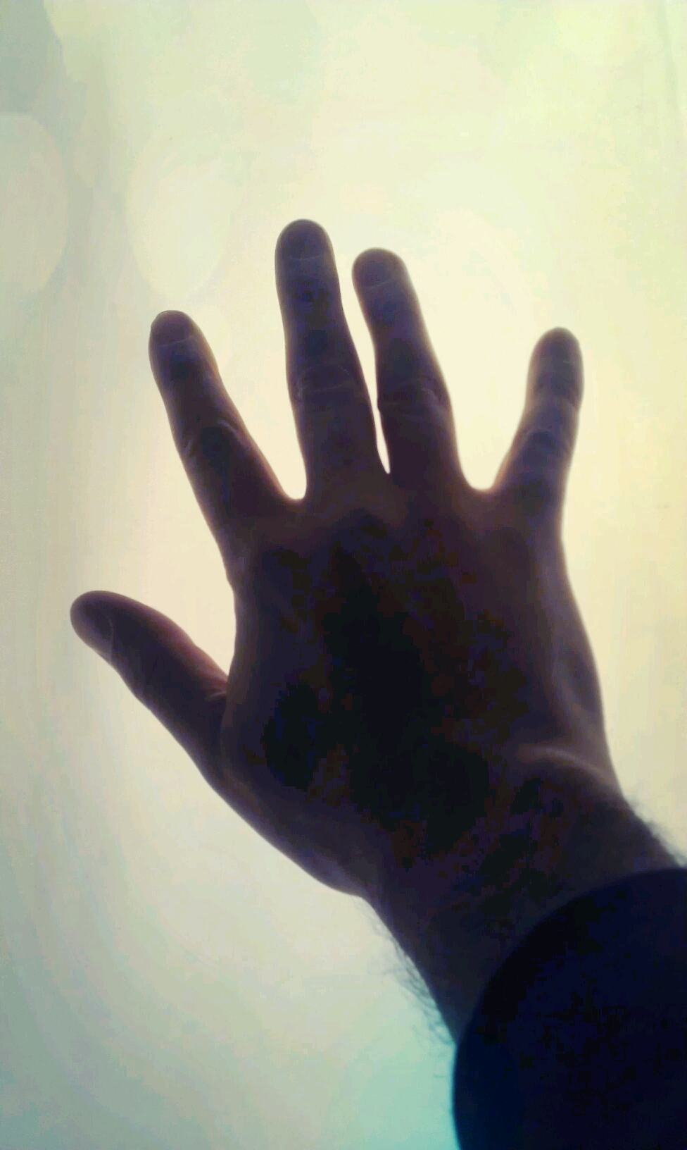 a hand reaching up into the air