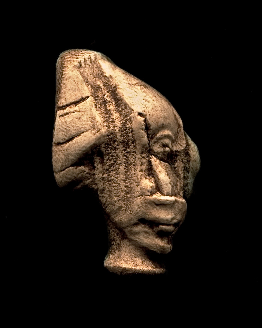 head of an ancient statue on a black background