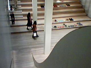 a woman with a purse is looking down the aisle of a building