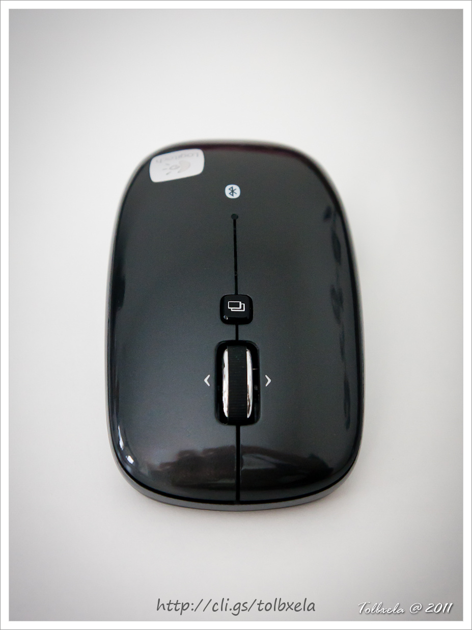 the top of a wireless mouse resting on the floor