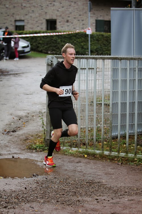 a man is running down a muddy road