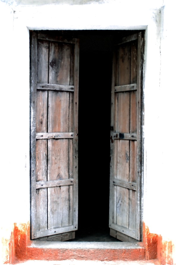 open doors at the entrance of a white painted building
