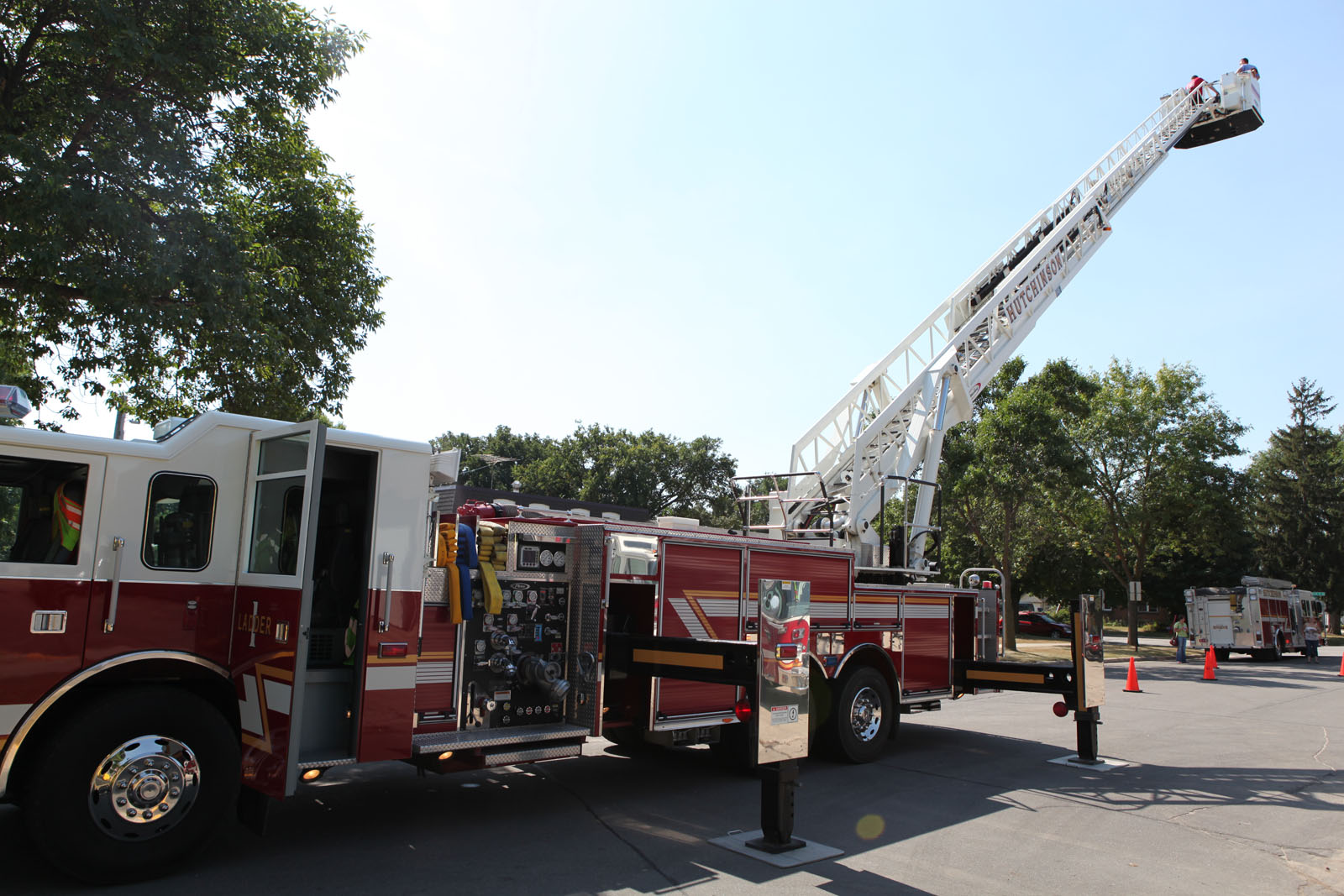 a fire truck with the ladder down in a parking lot