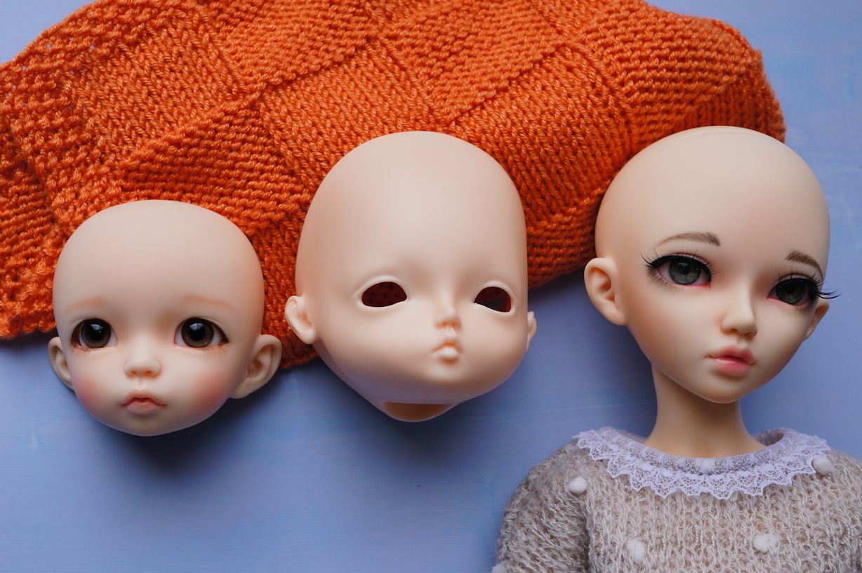 three dolls in sweaters and two of the doll are identical