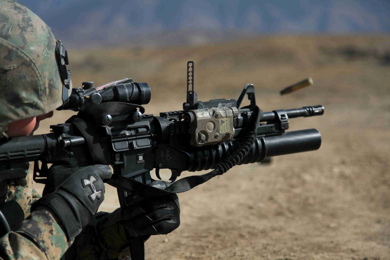 a soldier with his weapon in hand and an empty can to the side