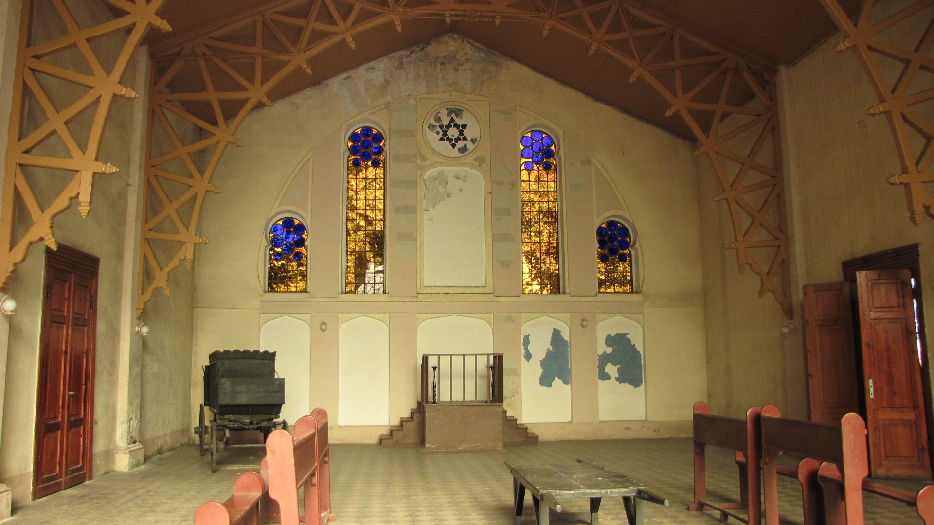 an old cathedral with two tables inside of it