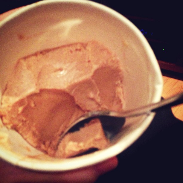 a bowl is filled with ice cream and a spoon