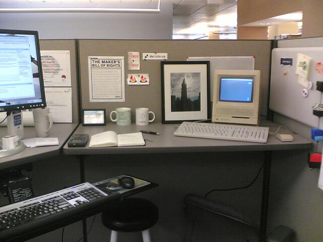 a computer desk is set up with different kinds of computers