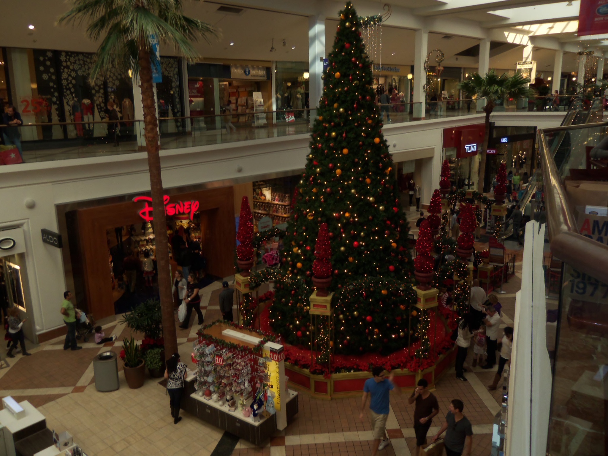 people are walking around inside of a shopping mall