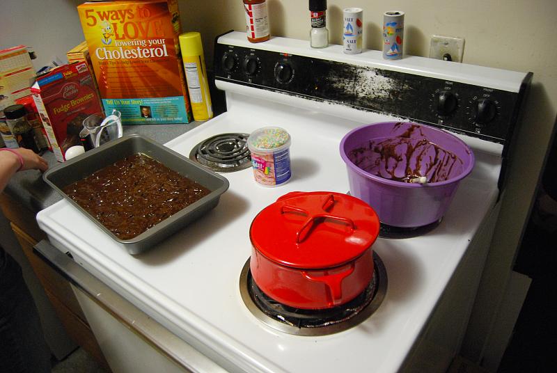 a stove top with cake and bowls on it