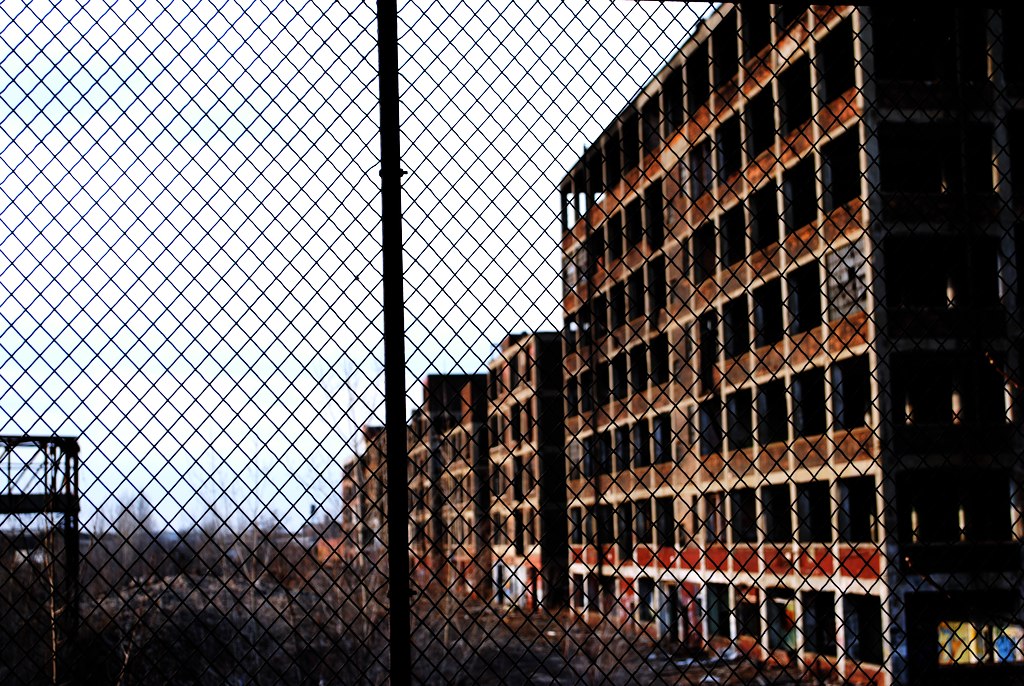 the side of a building is behind a wire fence