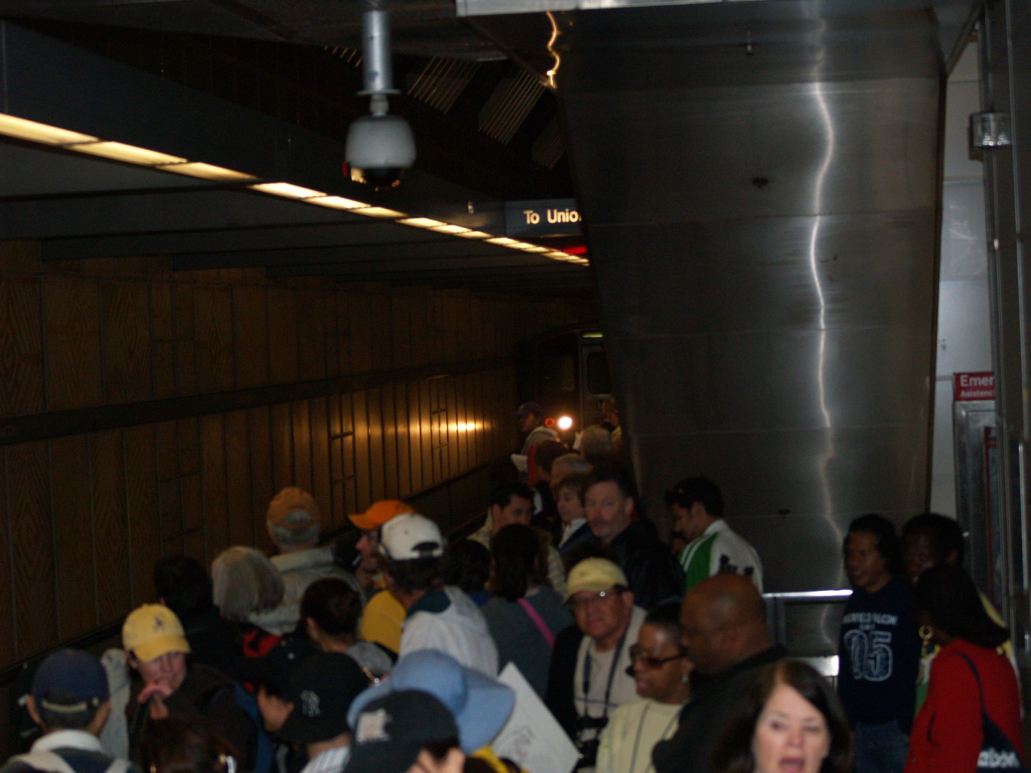 a group of people are riding an escalator