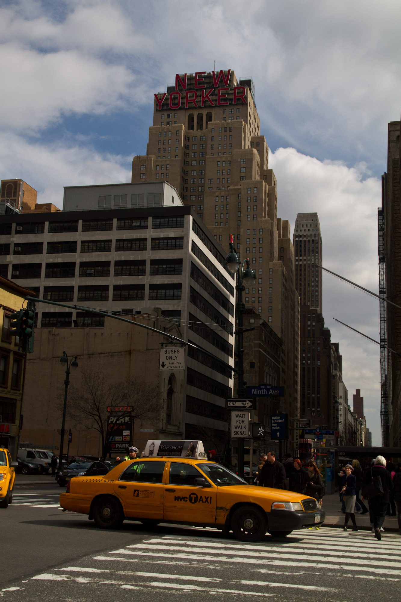 a taxi cab and pedestrians on a city street