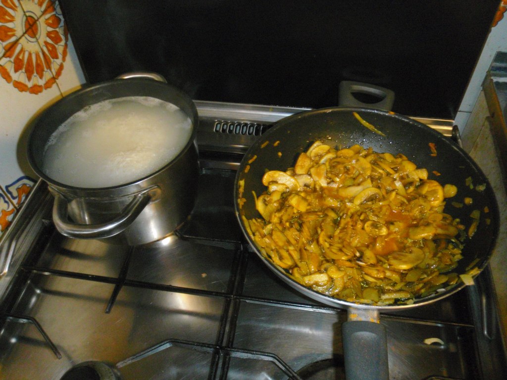 a pot is sitting on a stove cooking food