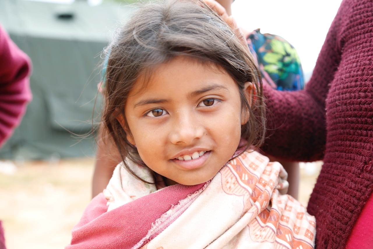 girl with blue eyes and wearing scarf and looking directly into the camera