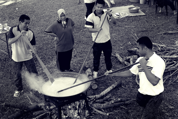 a group of people on a field cooking