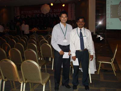 two men standing next to each other in a room