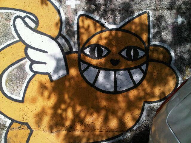 a graffiti mural is shown with an orange cat