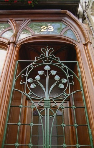 an intricate iron door in an old building