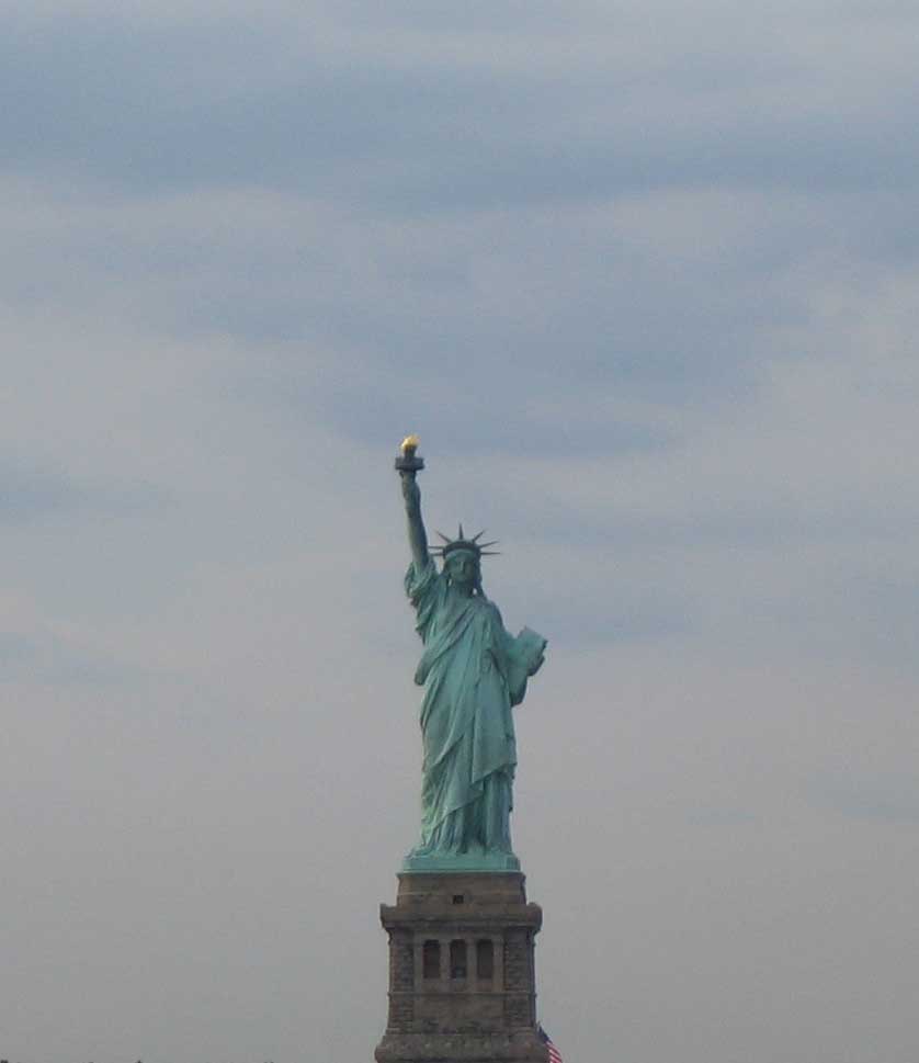 a big statue of liberty that is on a hill